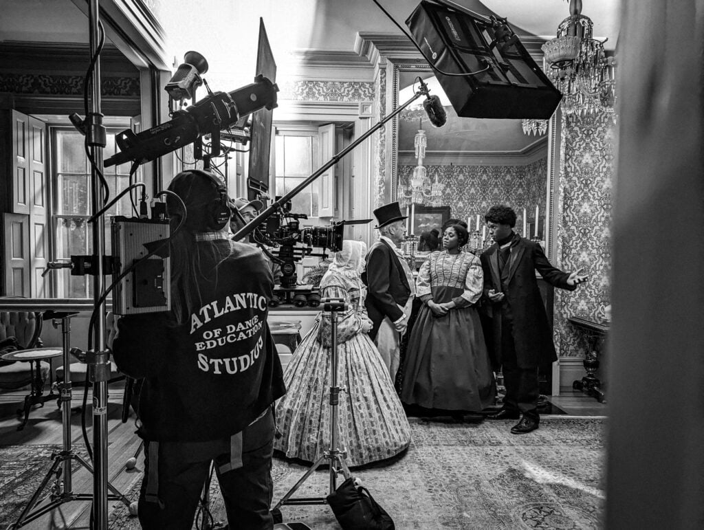 A black and white photo still from behind the scenes making the film Sweet Freedom by Alyssa Botelho about Mary Polly Johnson.