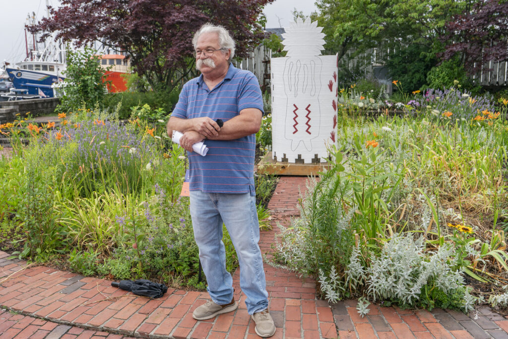 July Seaport Art Walk photograph of artist Eric Lintala in front of his sculpture. 